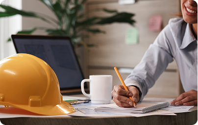 Hard hat on a desk beside workers compensation paperwork