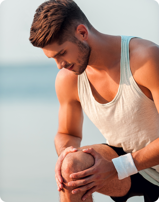 Athlete crouching and holding his knee